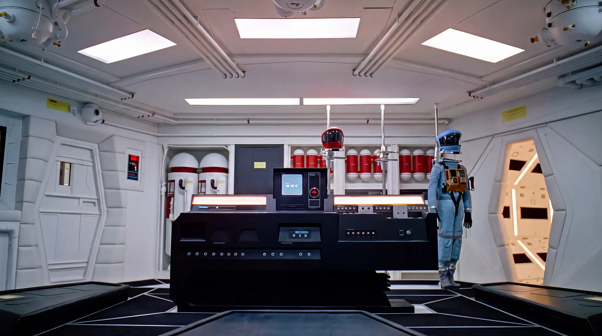 The Discovery flight deck, red eye above the console, astronaut by the door.
